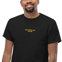 Queens Country Club T-shirt featuring minimalist front text 'Queens Country Club New York' and bold back graphic of NYC borough map with golf flags. Public golf streetwear celebrating New York City's municipal golf culture