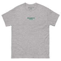 Queens Country Club T-shirt featuring minimalist front text 'Queens Country Club New York' and bold back graphic of NYC borough map with golf flags. Public golf streetwear celebrating New York City's municipal golf culture