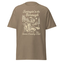 Queens Country Club T-shirt featuring vintage-style golf squirrel mascot driving a golf cart with NYC skyline, Unisphere, and Queensboro Bridge in background. Swingin' in the Borough golf streetwear for New York golfers