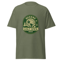 Military Green unisex T-shirt featuring a vintage-style graphic for the "Queens Golf Open 2025." The design includes the Unisphere at the center, surrounded by silhouettes of iconic NYC buildings, a golf ball, and a flagstick. The text "QUEENS GOLF OPEN 2025" is prominently displayed in cream and green tones within a badge-like emblem.
