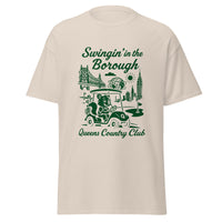Queens Country Club T-shirt featuring vintage-style golf squirrel mascot driving a golf cart with NYC skyline, Unisphere, and Queensboro Bridge in background. Swingin' in the Borough golf streetwear for New York golfers