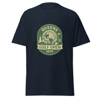 Navy blue unisex T-shirt featuring a vintage-style graphic for the "Queens Golf Open 2025." The design includes the Unisphere at the center, surrounded by silhouettes of iconic NYC buildings, a golf ball, and a flagstick. The text "QUEENS GOLF OPEN 2025" is prominently displayed in cream and green tones within a badge-like emblem.