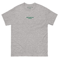 Queens Country Club T-shirt featuring minimalist front text 'Queens Country Club New York' and bold back graphic of NYC borough map with golf flags. Public golf streetwear celebrating New York City's municipal golf culture