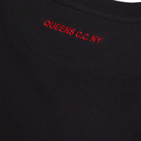 Black tee back neck – Close-up of red “QUEENS C.C. NY” embroidery on the back of a black tee