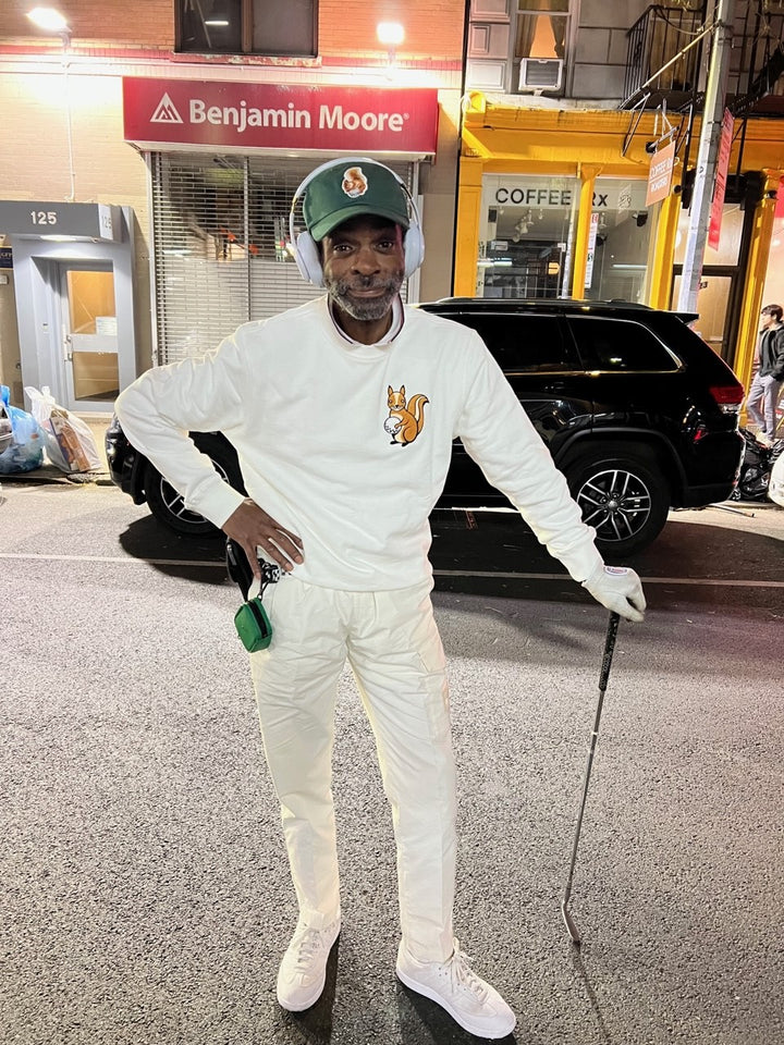 TIGERHOOD wearing queens country club squirrel sweatshirts 