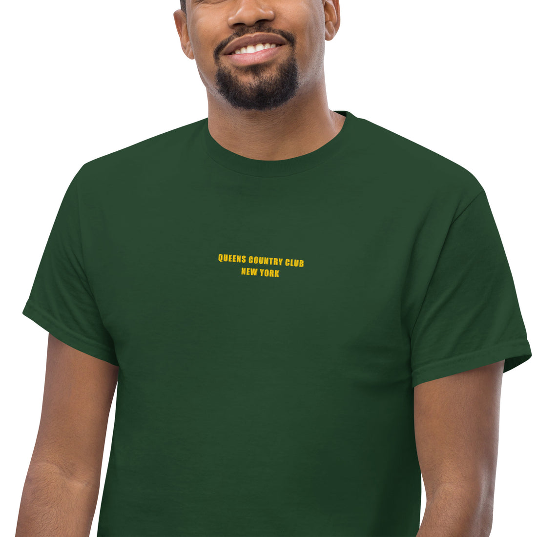   Queens Country Club T-shirt featuring minimalist front text 'Queens Country Club New York' and bold back graphic of NYC borough map with golf flags. Public golf streetwear celebrating New York City's municipal golf culture
