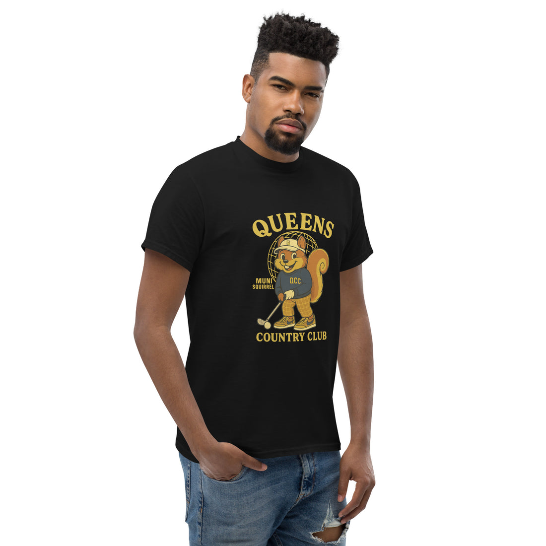  Queens Country Club black graphic T-shirt featuring cartoon golf squirrel mascot 'Muni Squirrel' in retro golf outfit with QCC sweatshirt, standing in front of Unisphere. Golf streetwear inspired by NYC municipal courses