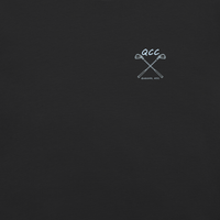QCC Iron Lineup Tee in Black, front view showing QCC crossed-club chest emblem.