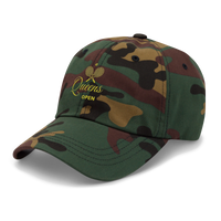Camouflage baseball cap with 'Queens Open' logo on a light gray background | Queens Country Club
